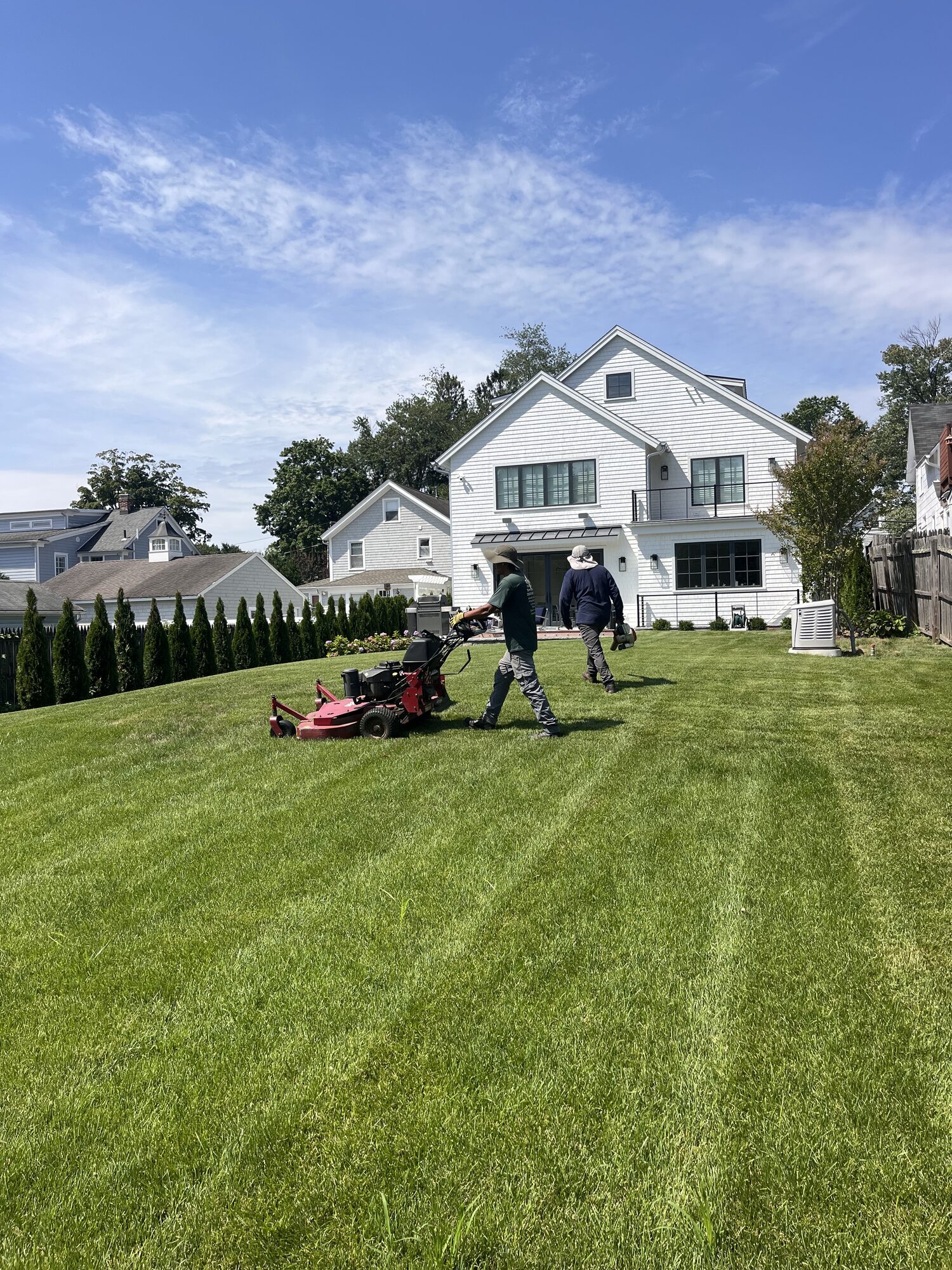 William mowing a lawn at a Rockland property
